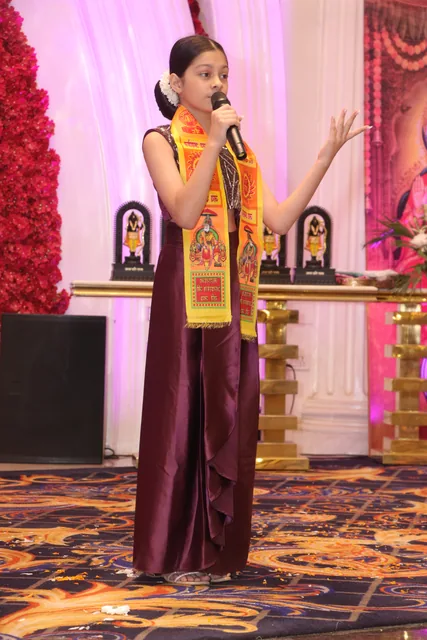 A speaker addressing the community during the celebration, photo 30, 17 October 2026